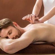 Young Man Receiving Back Massage At Spa