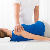 Masseur Doing Massage On Woman